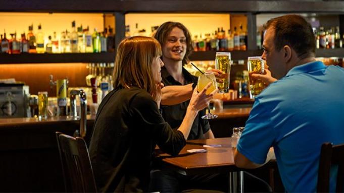 local pub with patrons cheersing their drinks
